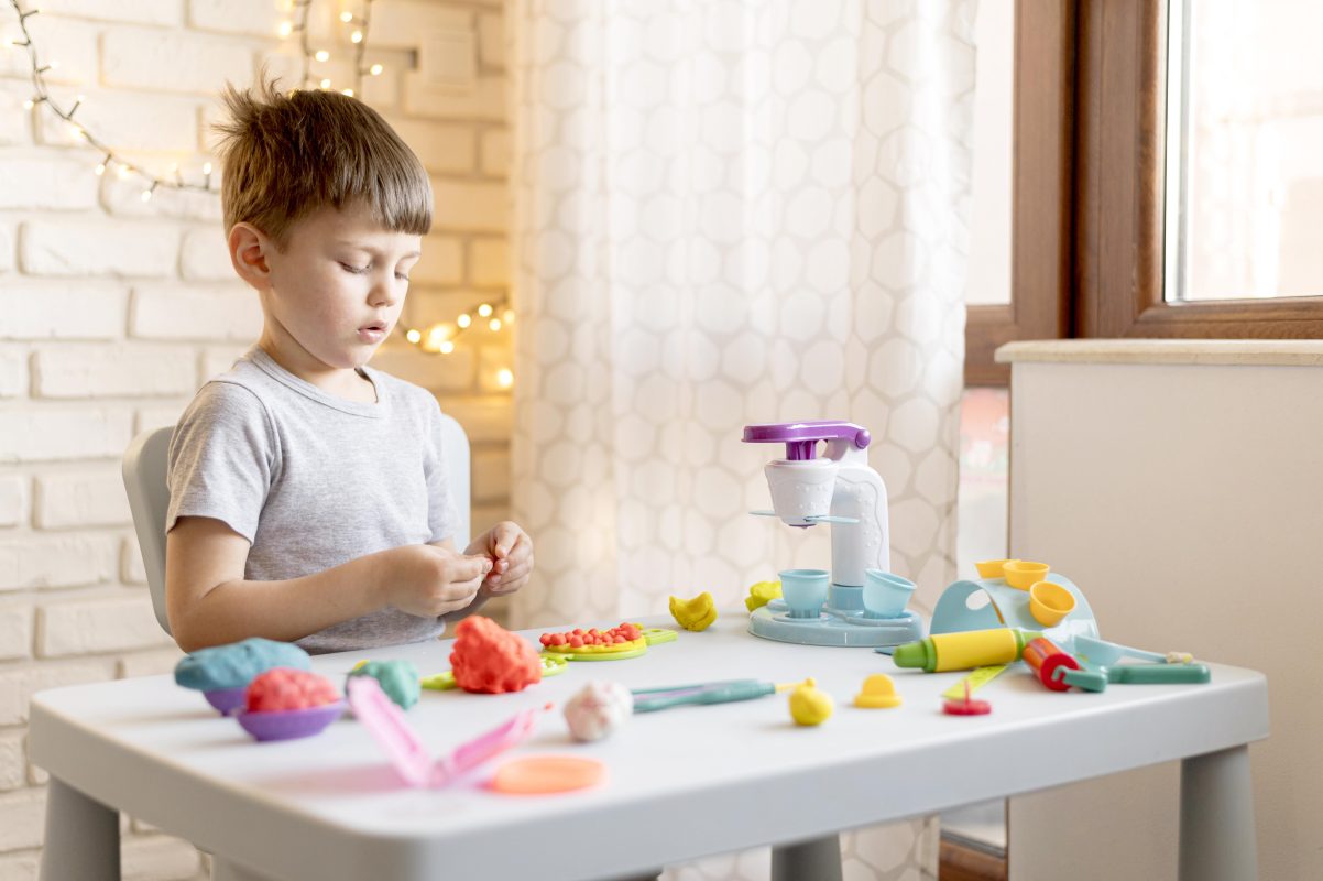 child-playing-sensory-toy-dough