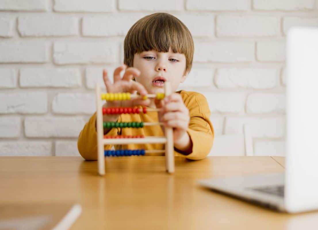 Child learning maths concepts using wooden Montessori educational toys