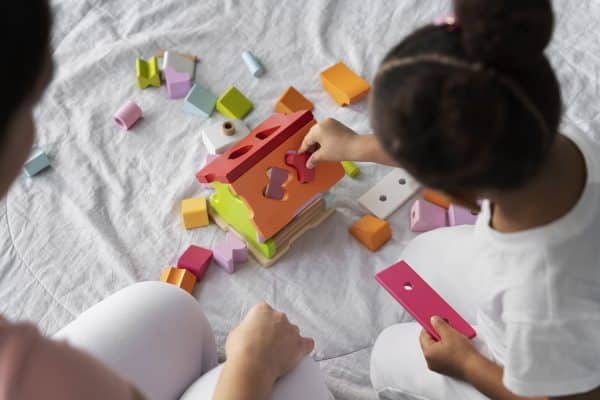 toddler using sensory toys for early childhood development at home