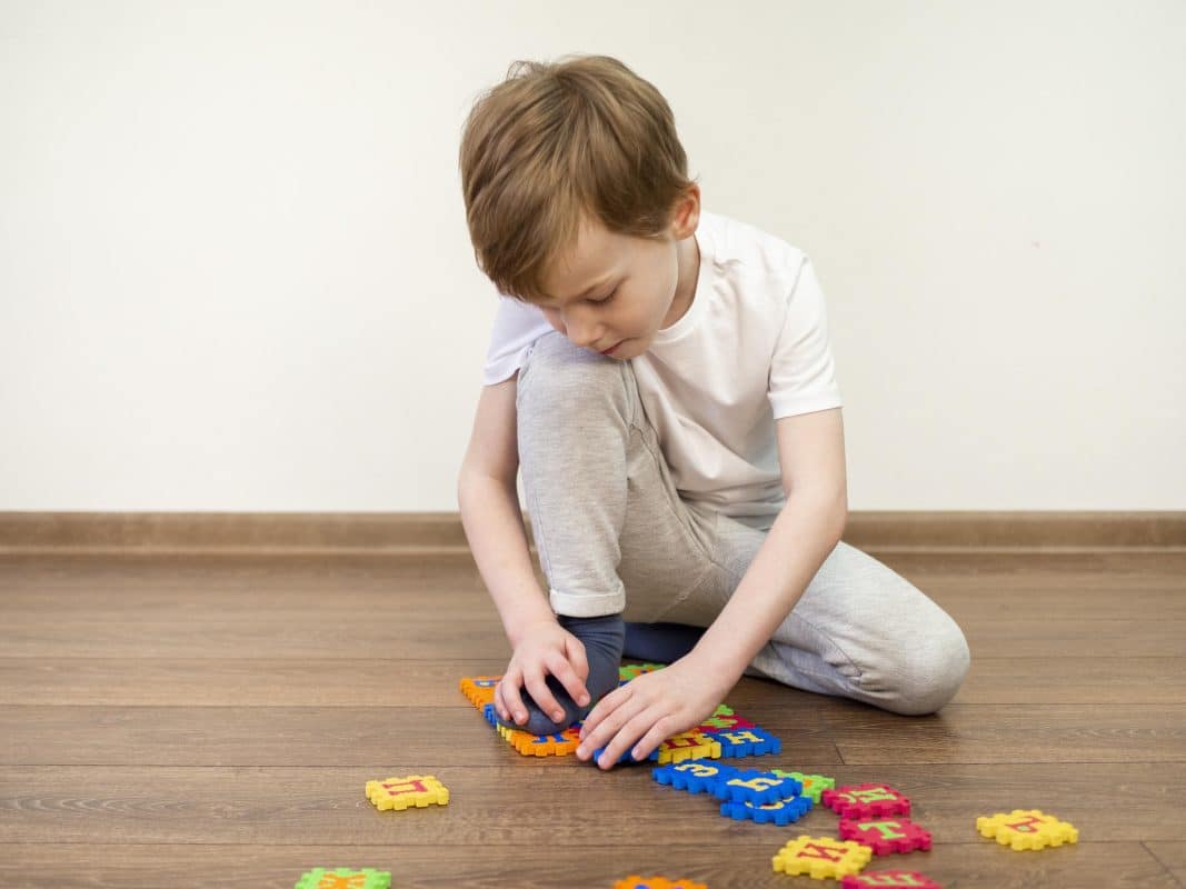 child solving logic puzzles for kids with educational wooden toys