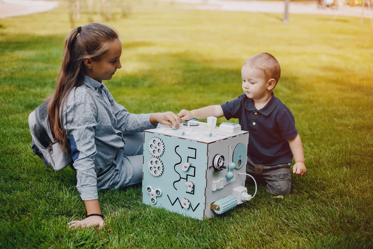baby using Montessori object permanence box for early learning