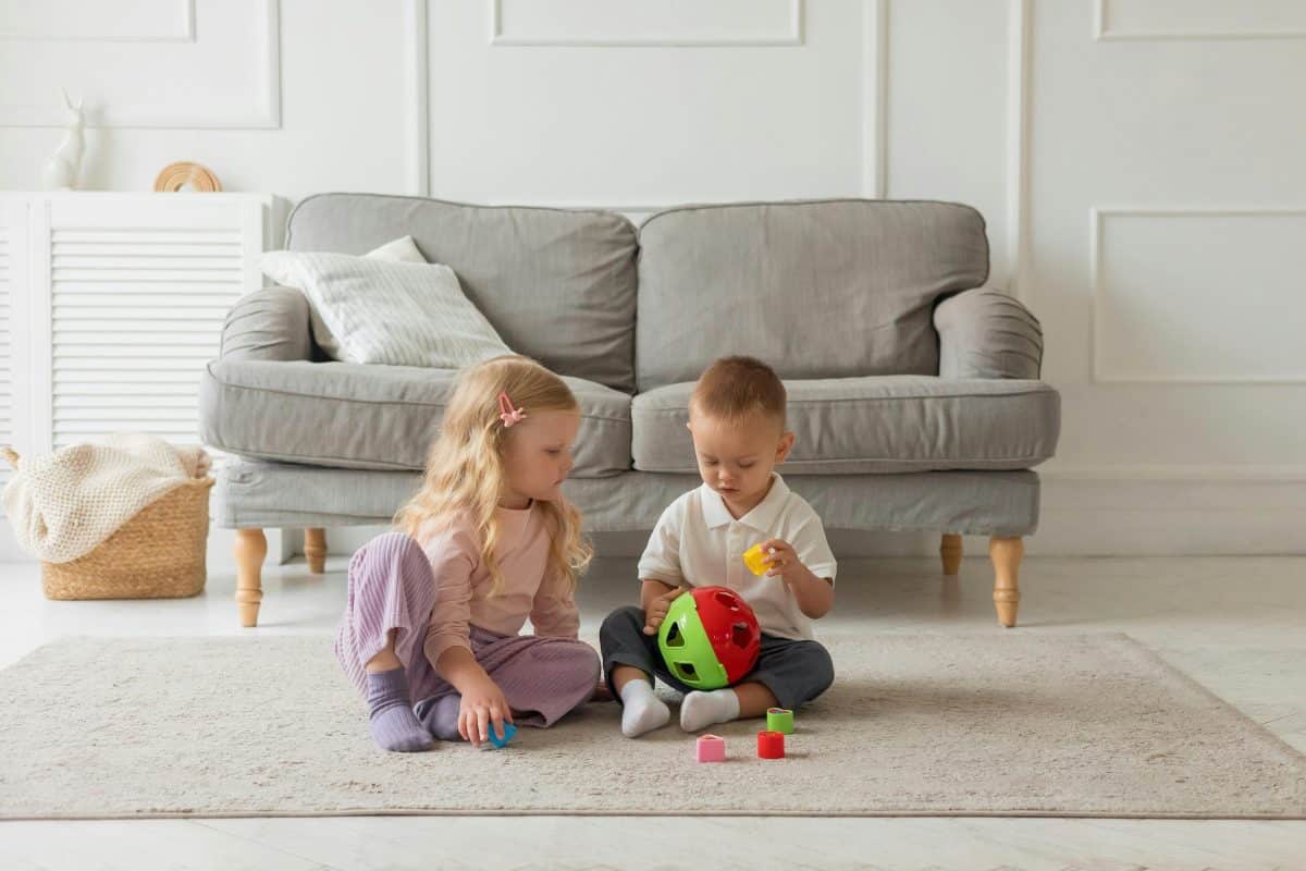 toddler practicing shape matching activities with Montessori toy