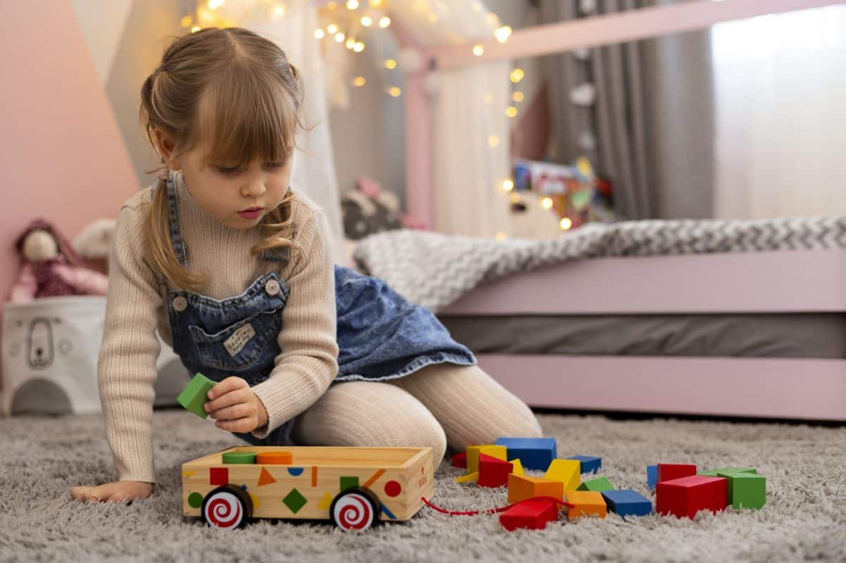 Toddler repeatedly playing with a Montessori wooden toy to build focus and learning skills