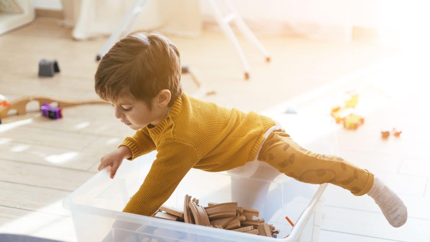 child dumps toys instead of playing